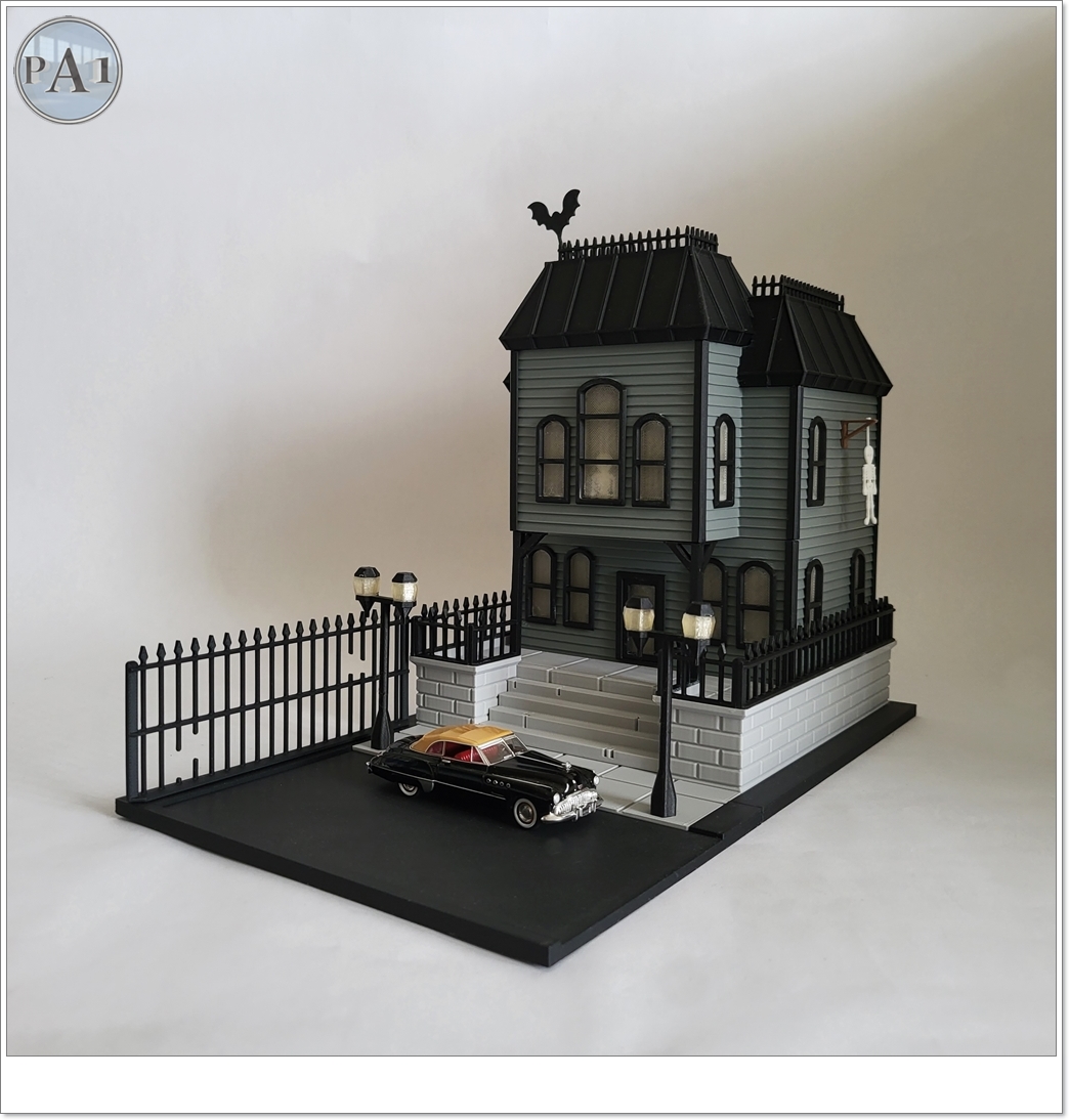 The Haunted Manor 3D printed Victorian haunted mansion on a hillside base with glowing windows