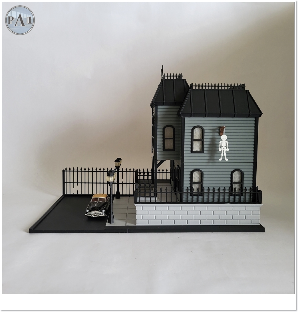 The Haunted Manor 3D printed Victorian haunted mansion on a hillside base with glowing windows