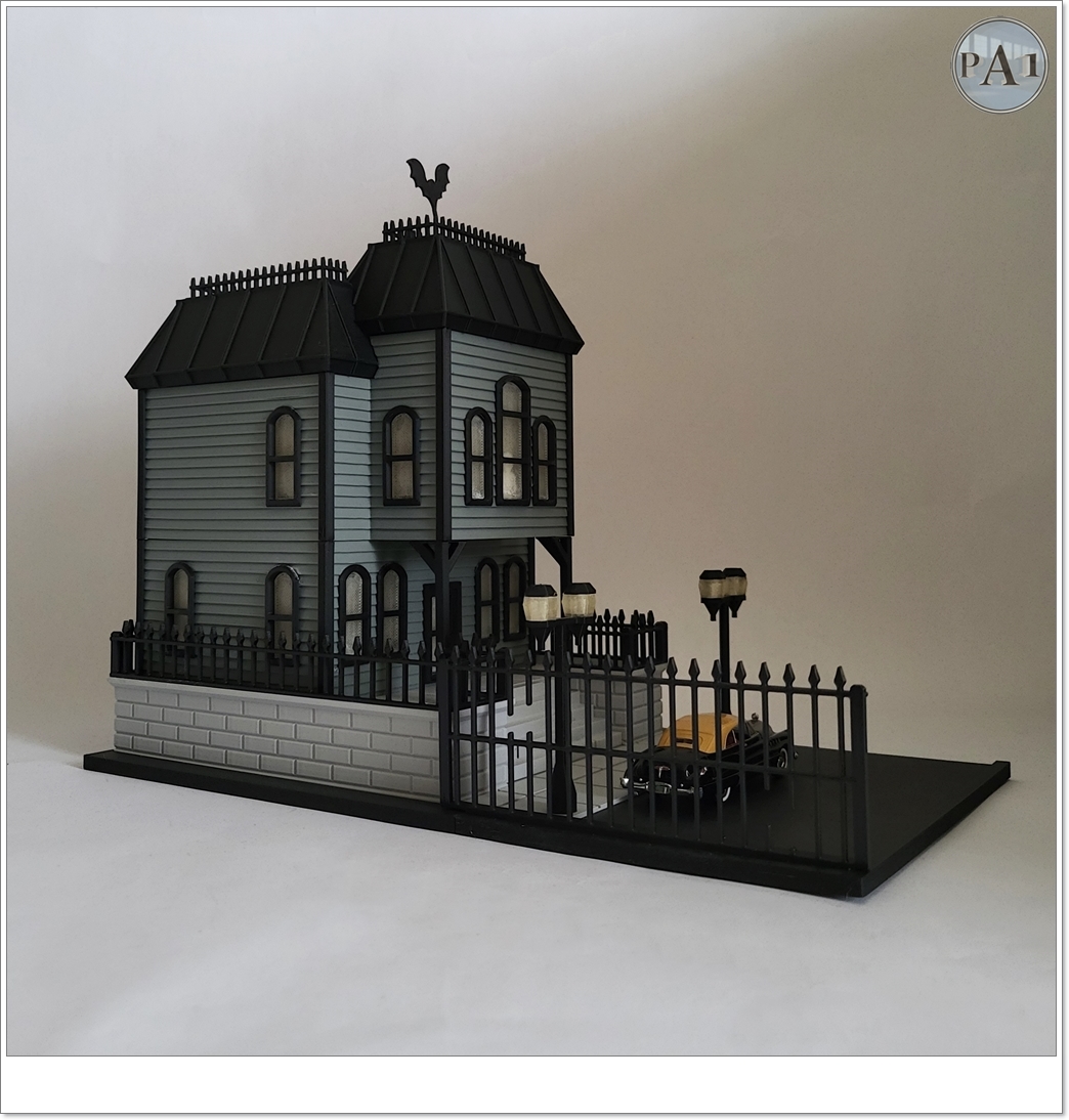 The Haunted Manor 3D printed Victorian haunted mansion on a hillside base with glowing windows