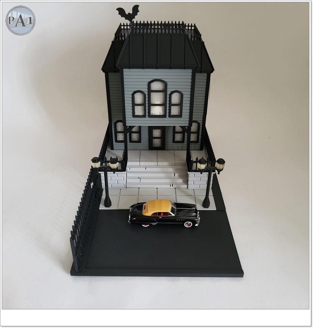 The Haunted Manor 3D printed Victorian haunted mansion on a hillside base with glowing windows
