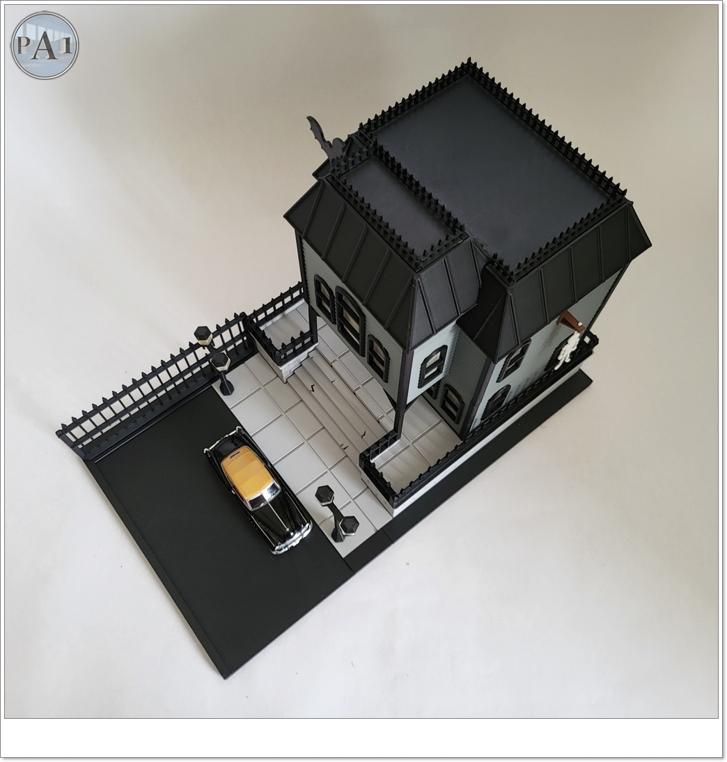 The Haunted Manor 3D printed Victorian haunted mansion on a hillside base with glowing windows