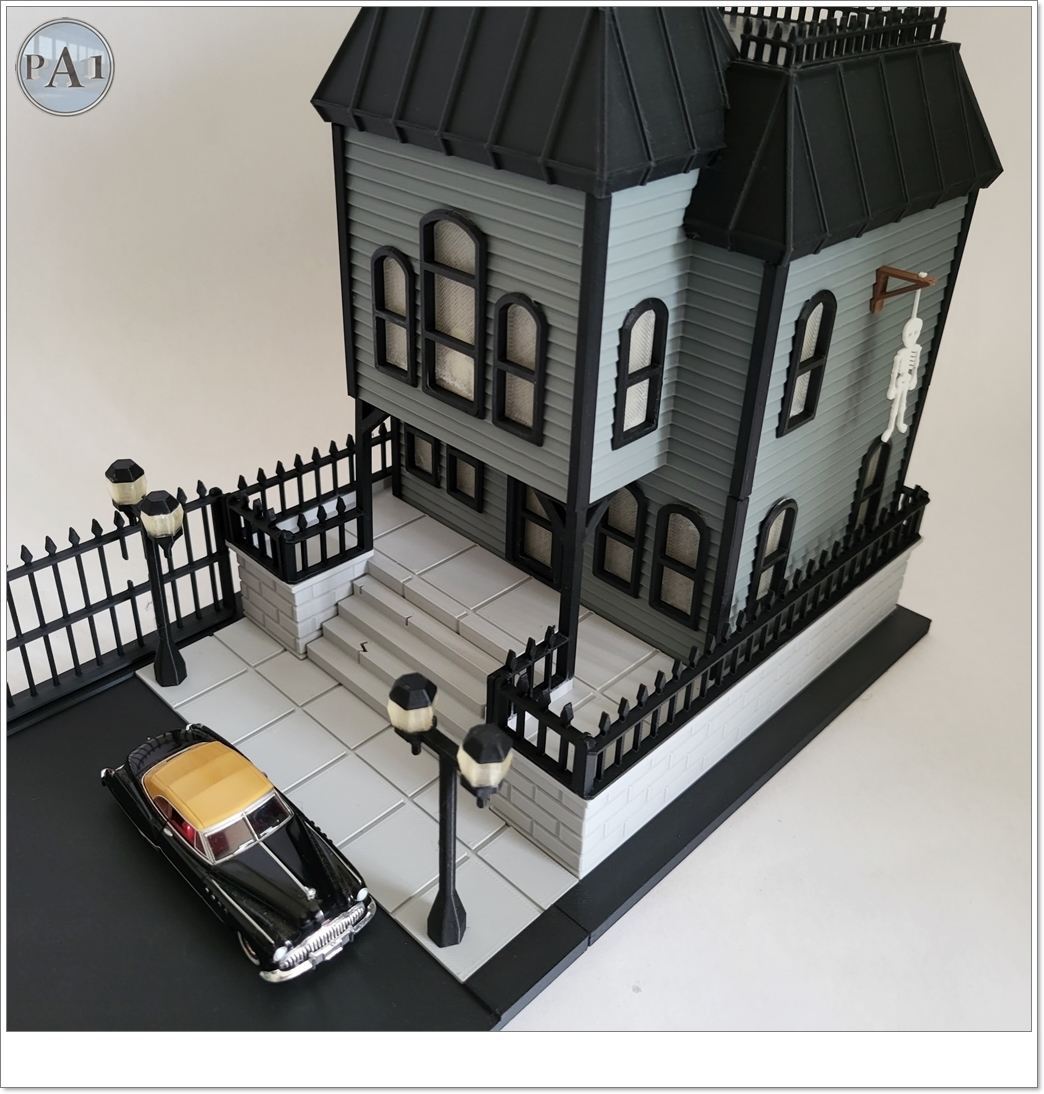 The Haunted Manor 3D printed Victorian haunted mansion on a hillside base with glowing windows