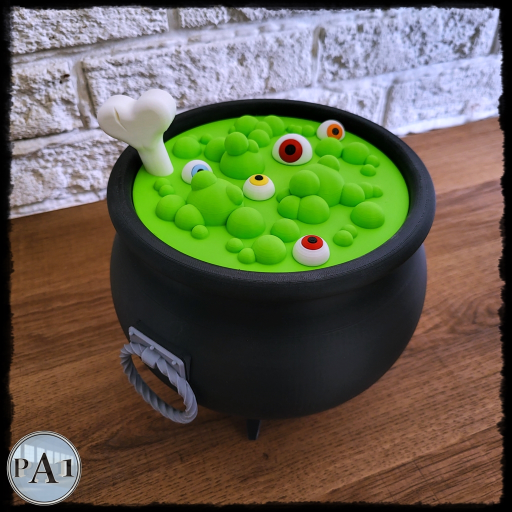 Witch's Brew Candy Bowl Cauldron 3D printed black cauldron with green bubbling brew lid, eyeballs and bone handle