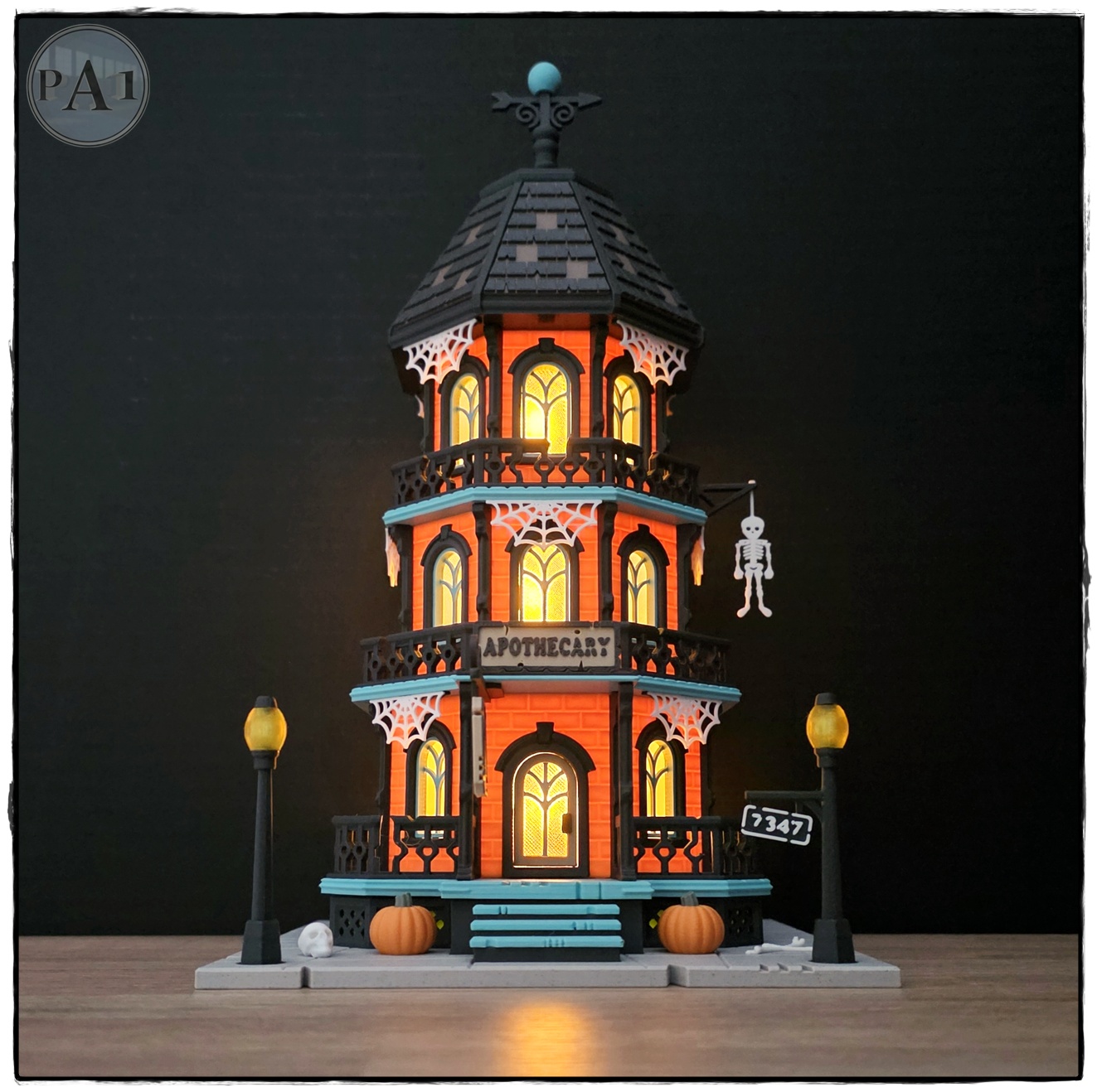 The Apothecary 3D printed three-story Victorian Halloween shop with street lamps, pumpkins and hanging skeleton