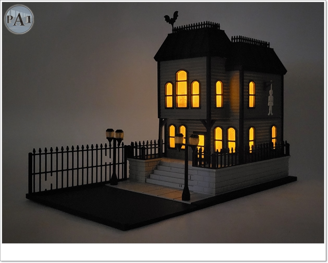 The Haunted Manor 3D printed Victorian haunted mansion on a hillside base with glowing windows