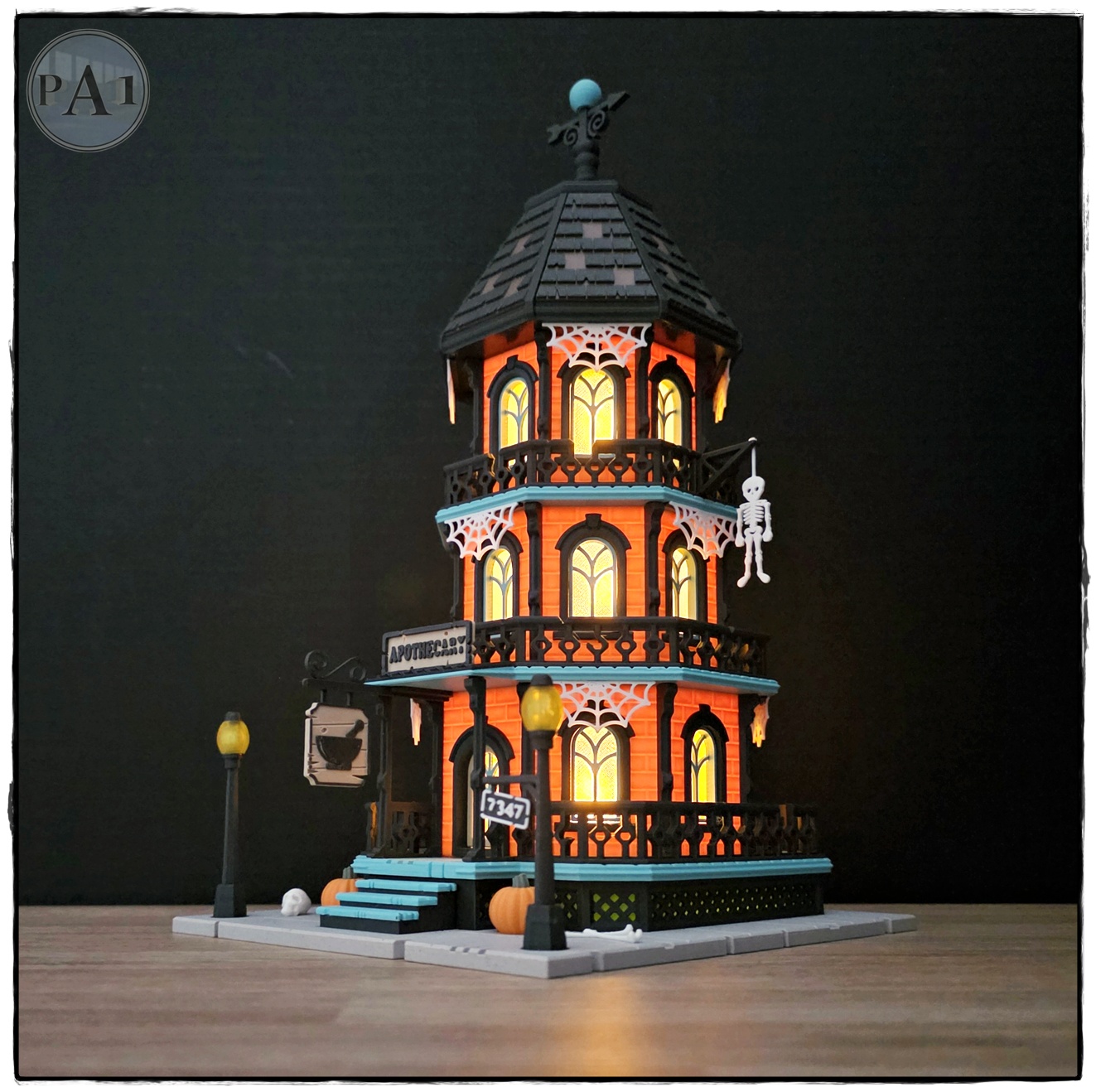 The Apothecary 3D printed three-story Victorian Halloween shop with street lamps, pumpkins and hanging skeleton