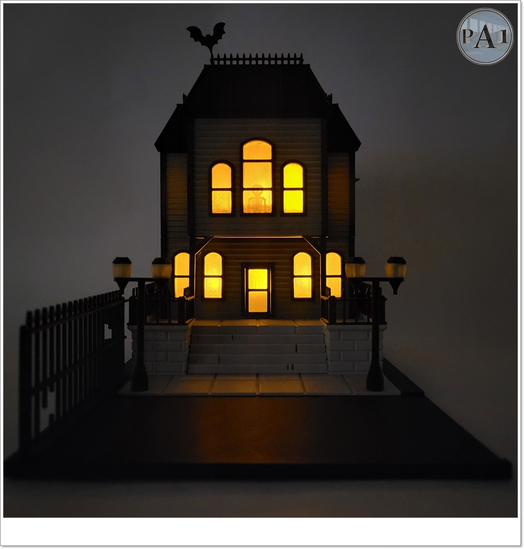 The Haunted Manor 3D printed Victorian haunted mansion on a hillside base with glowing windows