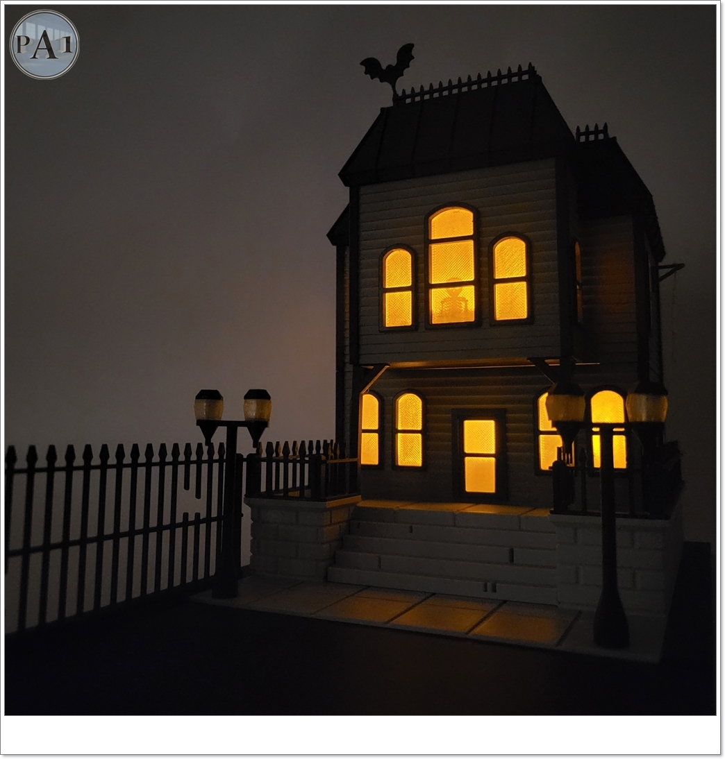 The Haunted Manor 3D printed Victorian haunted mansion on a hillside base with glowing windows