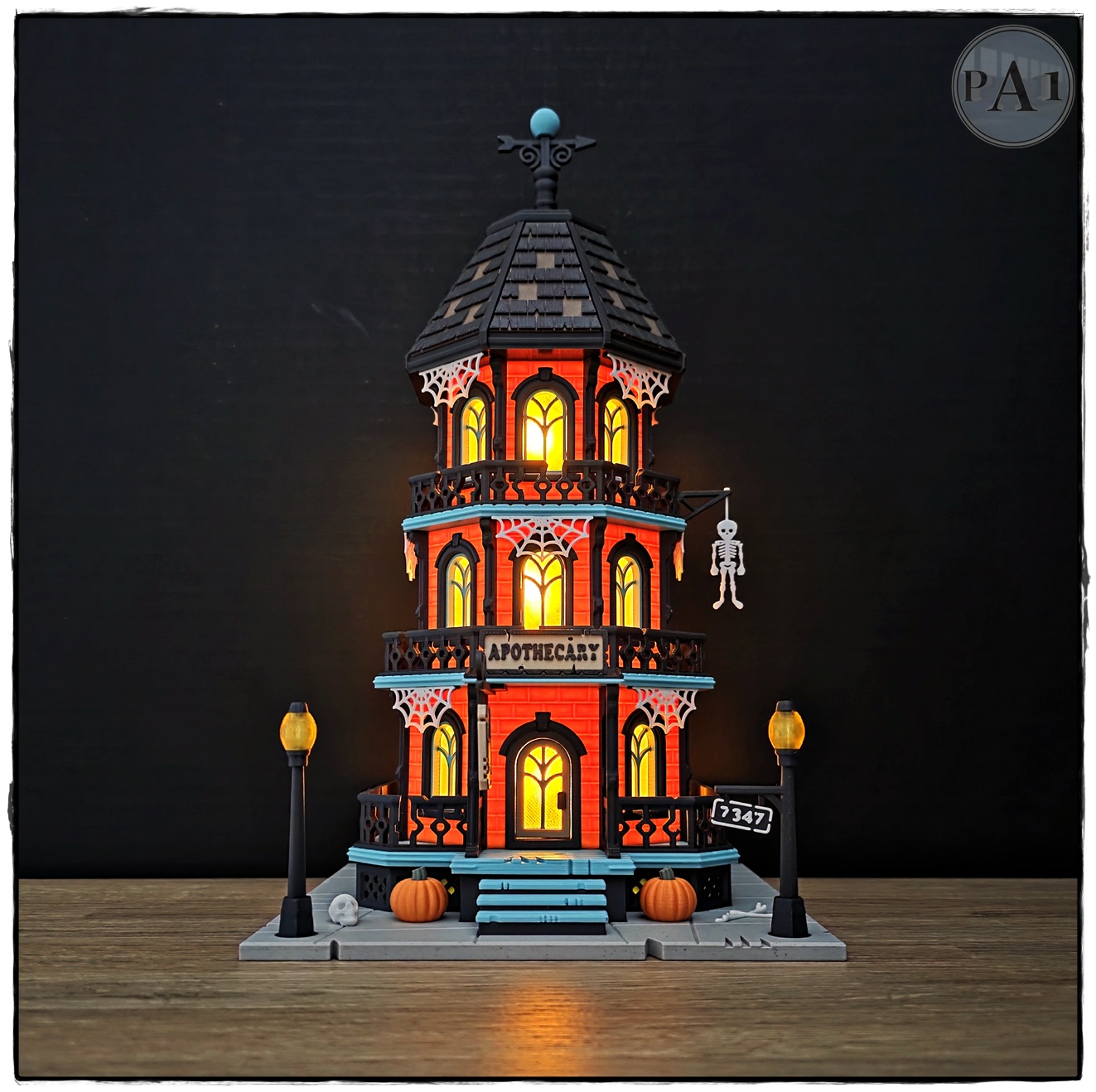 The Apothecary 3D printed three-story Victorian Halloween shop with street lamps, pumpkins and hanging skeleton
