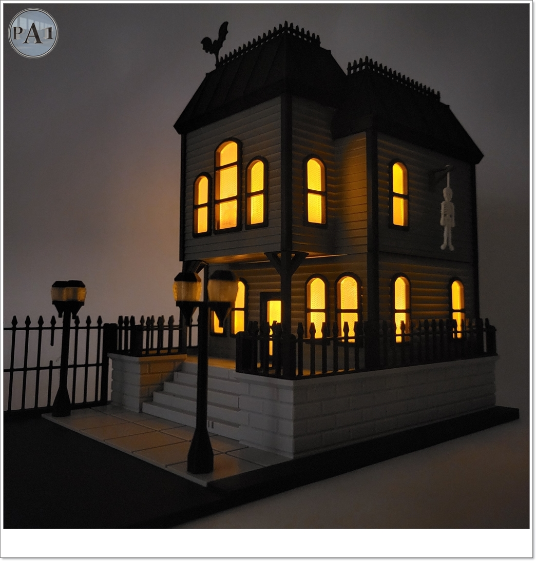 The Haunted Manor 3D printed Victorian haunted mansion on a hillside base with glowing windows