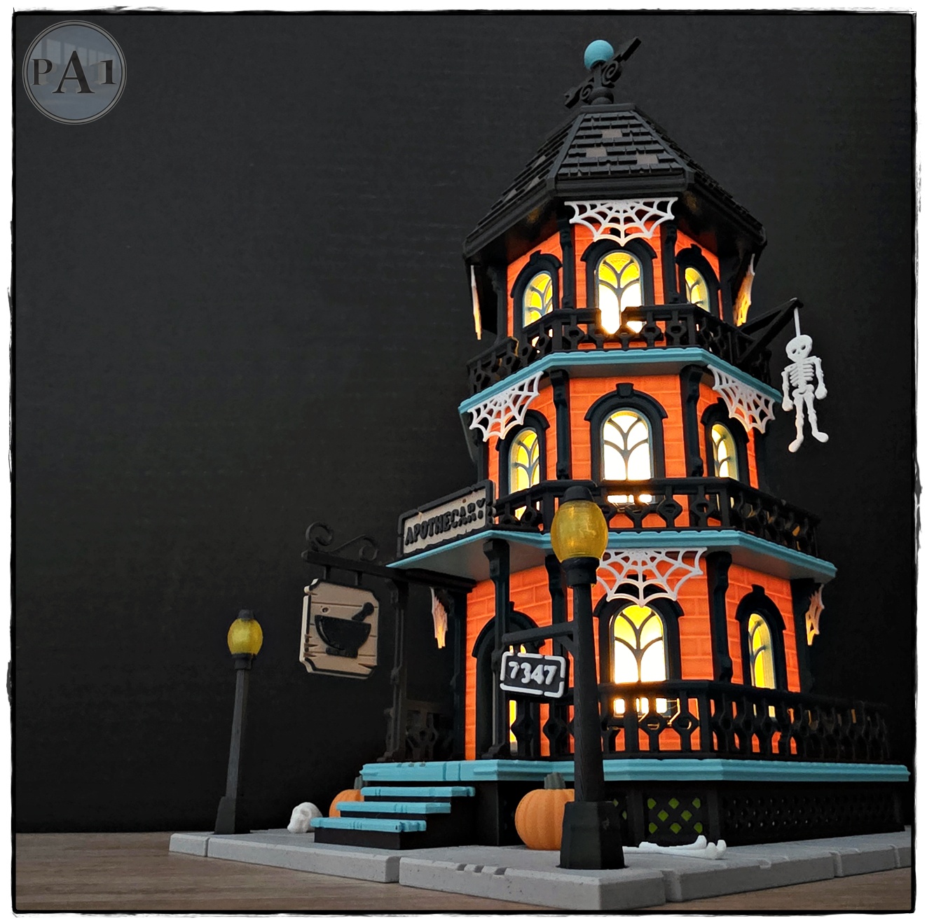 The Apothecary 3D printed three-story Victorian Halloween shop with street lamps, pumpkins and hanging skeleton