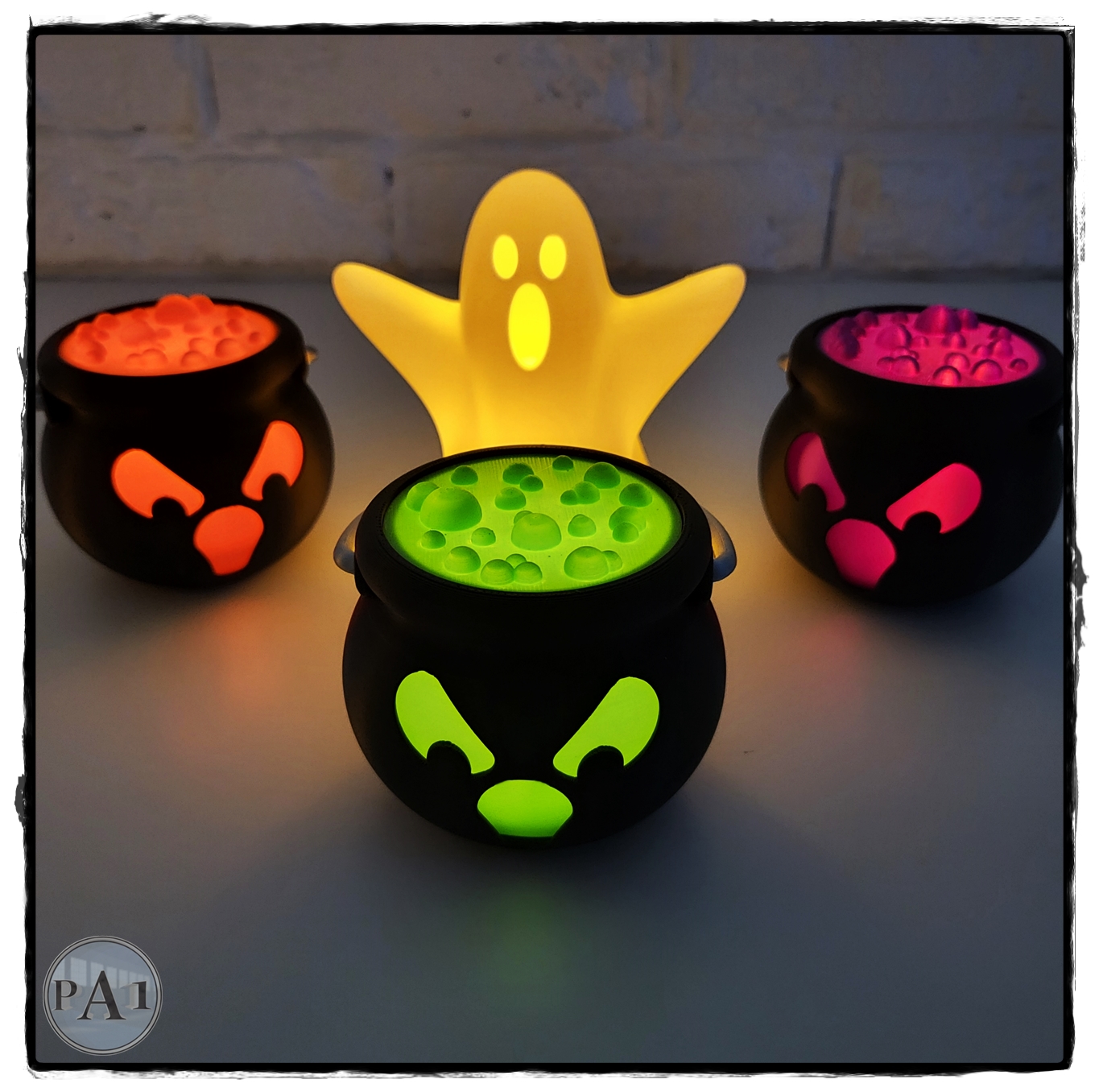 Green Tealight Spooky Cauldron glowing in front of a lit ghost