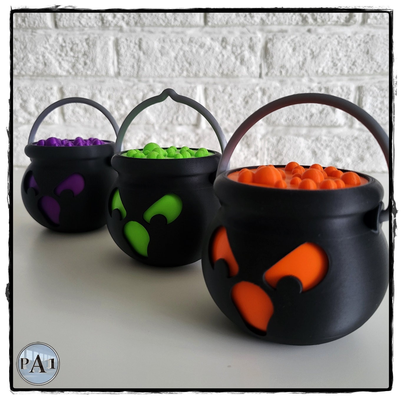 Purple, green and orange Tealight Spooky Cauldrons with swinging handles