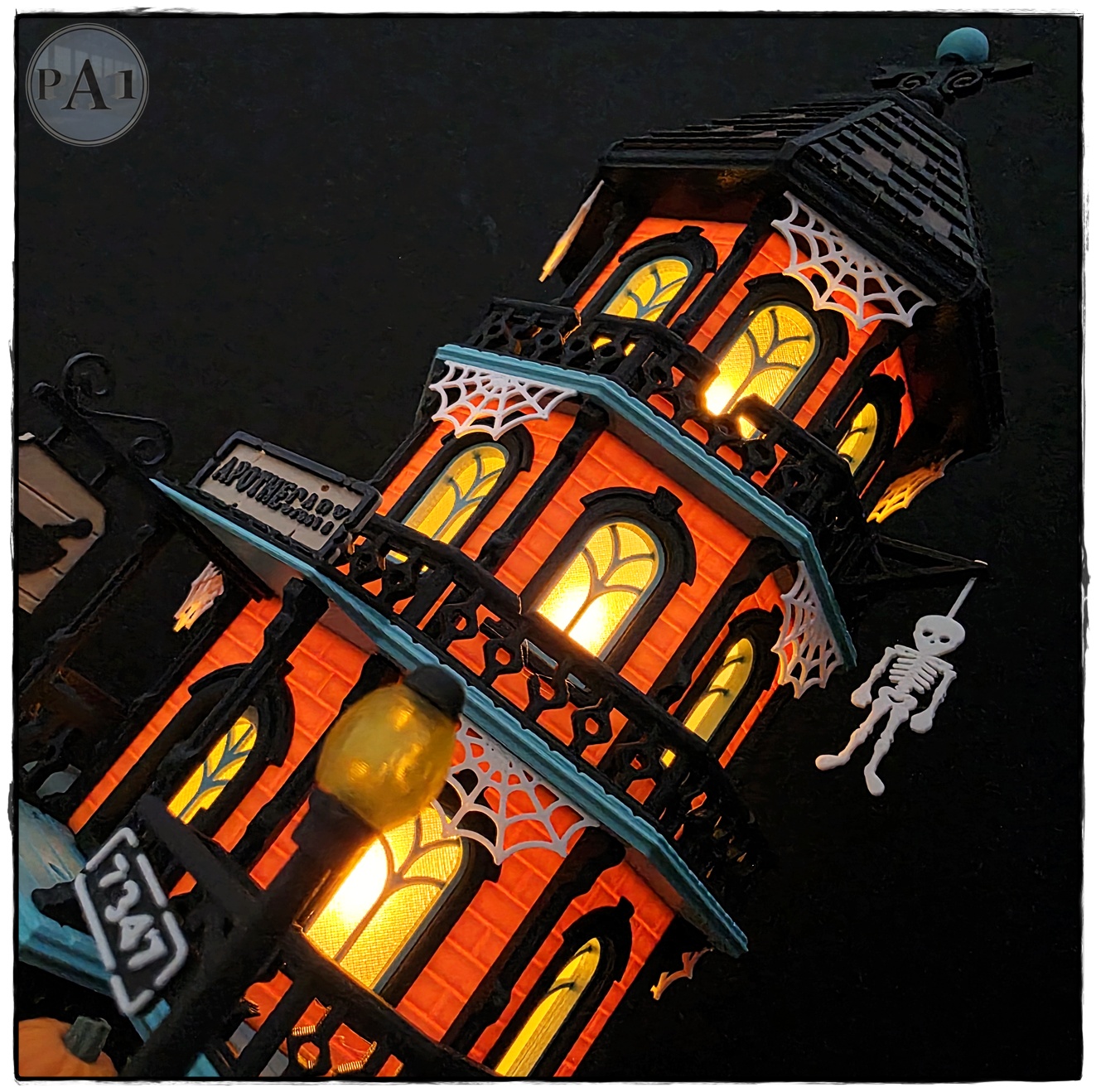 The Apothecary 3D printed three-story Victorian Halloween shop with street lamps, pumpkins and hanging skeleton