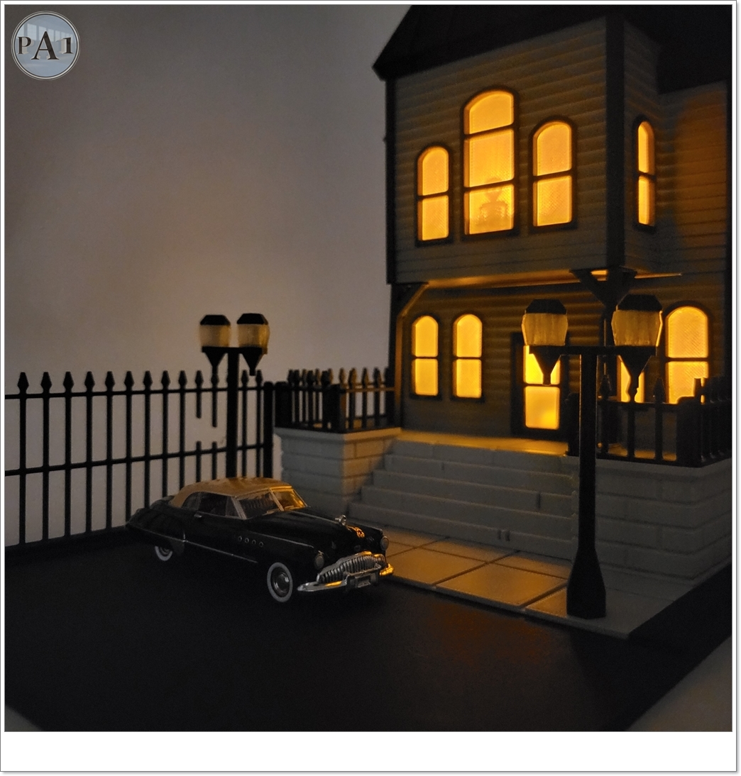 The Haunted Manor 3D printed Victorian haunted mansion on a hillside base with glowing windows